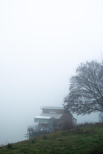 Foggy riverside boathouse